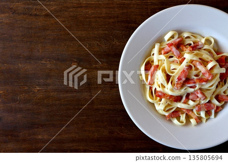 Tagliatelle carbonara on a table background viewed from above Tagliatelle carbonara on a table background viewed from above 135805694