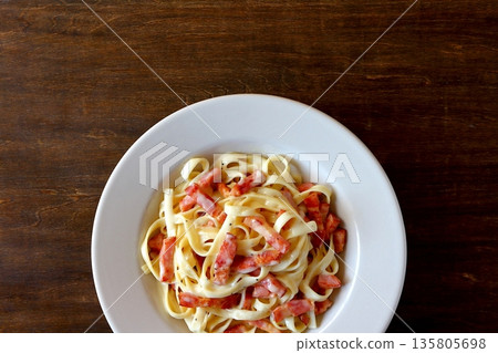 Tagliatelle carbonara on a table background viewed from above Tagliatelle carbonara on a table background viewed from above 135805698