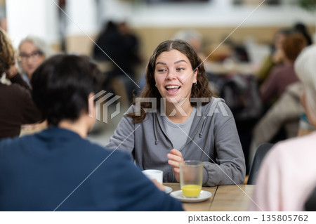Large friendly family gathered at table to have meeting in restaurant Large friendly family gathered at table to have meeting in restaurant 135805762