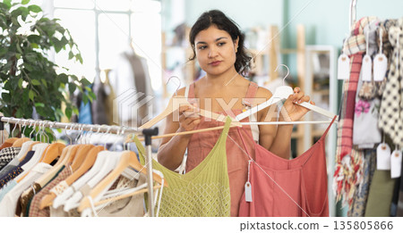 Girl at trading floor pick out and buying sundress or tank top Girl at trading floor pick out and buying sundress or tank top 135805866