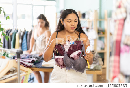 Girl at trading floor pick out and buying bra Girl at trading floor pick out and buying bra 135805885