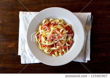 Tagliatelle carbonara on a table background viewed from above Tagliatelle carbonara on a table background viewed from above 135805907