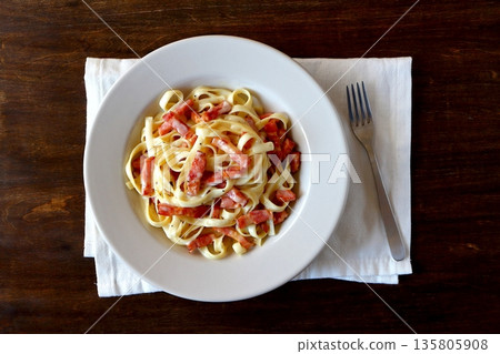 Tagliatelle carbonara on a table background viewed from above Tagliatelle carbonara on a table background viewed from above 135805908