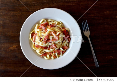 Tagliatelle carbonara on a table background viewed from above 135805909