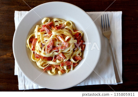 Tagliatelle carbonara on a table background viewed from above Tagliatelle carbonara on a table background viewed from above 135805911
