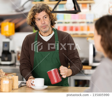 Portrait of middle-aged man barista pouring freshly brewed coffee into cup in cafe Portrait of middle-aged man barista pouring freshly brewed coffee into cup in cafe 135805990
