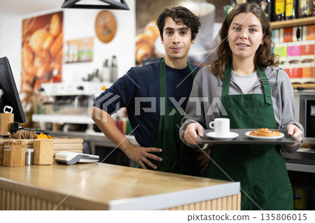 Portrait of two friendly cafe employees indoor Portrait of two friendly cafe employees indoor 135806015