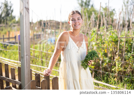 Portrait of young housewife of village house against the backdrop of estate Portrait of young housewife of village house against the backdrop of estate 135806114