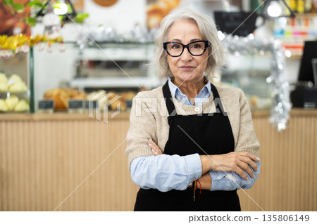 Friendly cafe employee invites you to visit establishment 135806149
