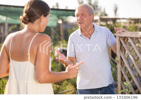 Young European woman and senior man neighbors quarrel and swear 135806196