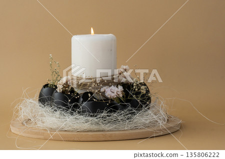 Creative handmade Easter table decoration with egg shells instruction candle on pastel beige background copy space. Greeting card idea Easter home tradition Seasonal sustainable recycled 135806222