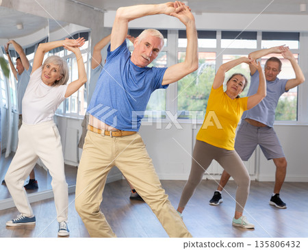 Elderly man dances modern dances in group 135806432