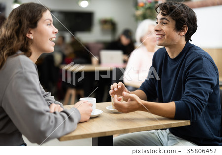 Girl in cafe sits near guy companion, work or romantic meeting dating Girl in cafe sits near guy companion, work or romantic meeting dating 135806452
