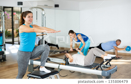 Young girl practicing pilates exercises on combo chair 135806479