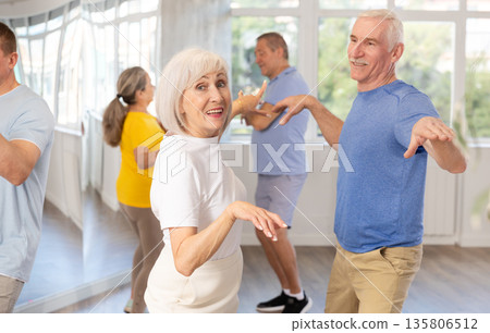 Couple of elderly man and woman dancing twist Couple of elderly man and woman dancing twist 135806512