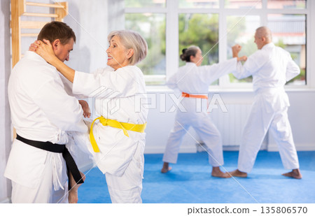 Senior judo practitioner engage in fierce fight Senior judo practitioner engage in fierce fight 135806570