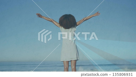 Stretching woman wearing white sleeveless dress at shoreline facing ocean, with waves rolling in Stretching woman wearing white sleeveless dress at shoreline facing ocean, with waves rolling in 135806931