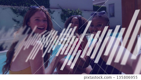 Smiling three women in swimwear holding glasses and smartphone at pool showing water and sunglasses Smiling three women in swimwear holding glasses and smartphone at pool showing water and sunglasses 135806955