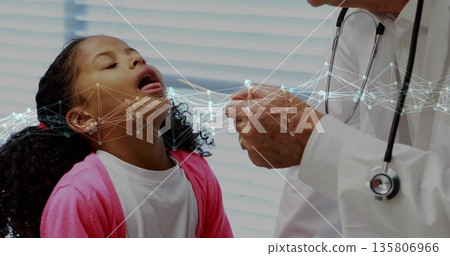 Girl opening mouth at clinic, with Dr in lab coat holding tongue depressor, stethoscope, copy space Girl opening mouth at clinic, with Dr in lab coat holding tongue depressor, stethoscope, copy space 135806966