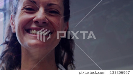 Smiling mid adult woman wearing white collared shirt in workspace, showing data on glass board Smiling mid adult woman wearing white collared shirt in workspace, showing data on glass board 135806967
