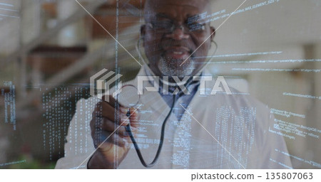 Holding stethoscope doctor wearing lab coat pointing toward viewer in clinic, with code overlay 135807063