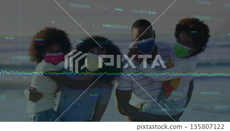 Embracing family wearing colorful face coverings standing on sandy beach at dusk, ocean backdrop Embracing family wearing colorful face coverings standing on sandy beach at dusk, ocean backdrop 135807122