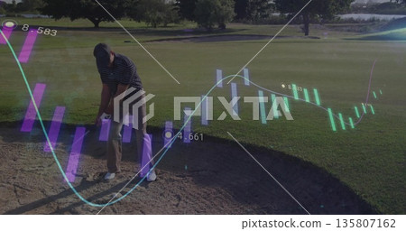 Swinging middle aged male golfer hitting golf ball from sand bunker, with translucent data overlays Swinging middle aged male golfer hitting golf ball from sand bunker, with translucent data overlays 135807162