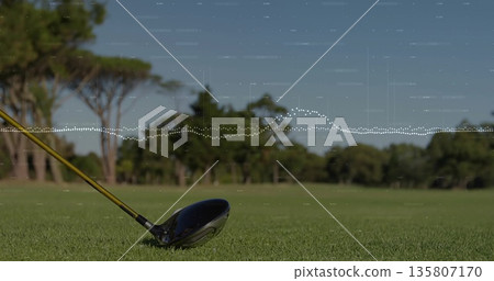 Showing golf driver head and shaft resting on fairway tee, with lush green turf, copy space 135807170