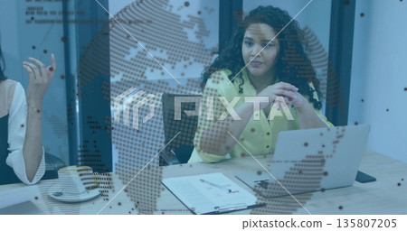 Listening businesswoman clasping hands at conference table, with laptop smartphone binder map decal 135807205