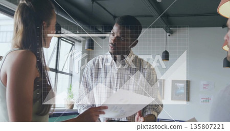 Discussing center subject holding printed chart in office meeting area, with digital grid overlay Discussing center subject holding printed chart in office meeting area, with digital grid overlay 135807221