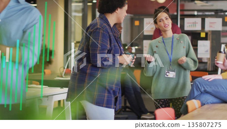Gesturing woman in green knit sweater conversing in modern workspace, with ceramic mug, whiteboard Gesturing woman in green knit sweater conversing in modern workspace, with ceramic mug, whiteboard 135807275