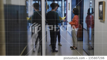 Talking three colleagues exchanging ideas in office corridor, with smartphone and yellow folder Talking three colleagues exchanging ideas in office corridor, with smartphone and yellow folder 135807286