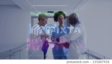 Doctors and nurse analyzing holographic vitals display in hospital corridor, with purple clipboard 135807458