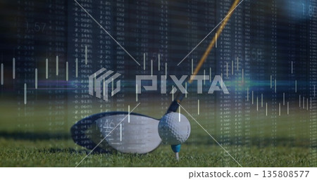 Golf driver sitting behind ball on blue tee at golf course, with financial market data overlay Golf driver sitting behind ball on blue tee at golf course, with financial market data overlay 135808577