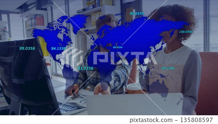 Collaborating coworkers analyzing data on laptop at office, with data map overlay and coffee cup 135808597