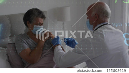 Injecting senior medic giving vaccine to patient at home with syringe and grid overlay, copy space Injecting senior medic giving vaccine to patient at home with syringe and grid overlay, copy space 135808619