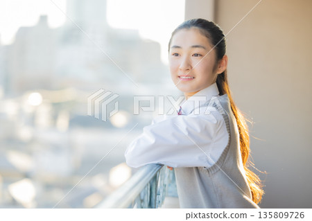 After school, a female junior high school student looks outside After school, a female junior high school student looks outside 135809726