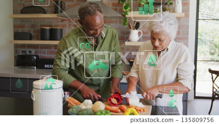 Chopping couple slicing vegetables at home kitchen island, with cutting board and chef's knives Chopping couple slicing vegetables at home kitchen island, with cutting board and chef's knives 135809756