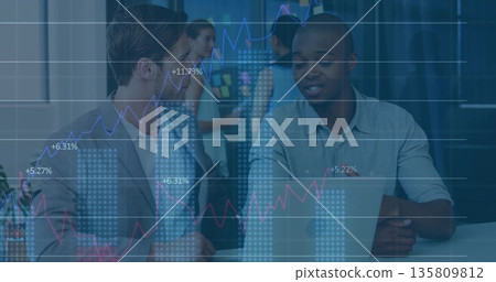 Collaborating business professionals analyzing laptop in office, with sticky board and data overlay Collaborating business professionals analyzing laptop in office, with sticky board and data overlay 135809812