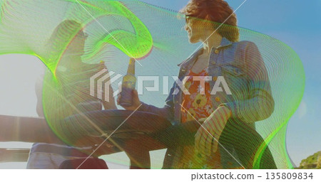 Sipping bottled drinks, man and woman sitting on bench by ocean under clear sky, wearing sunglasses Sipping bottled drinks, man and woman sitting on bench by ocean under clear sky, wearing sunglasses 135809834