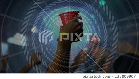 Raising arm holding red plastic cup at concert venue, with event wristbands and stage lights Raising arm holding red plastic cup at concert venue, with event wristbands and stage lights 135809907