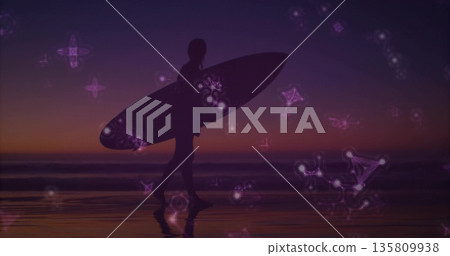 Walking silhouette surfer carrying surfboard on wet sand shore at dusk, with glowing constellations Walking silhouette surfer carrying surfboard on wet sand shore at dusk, with glowing constellations 135809938