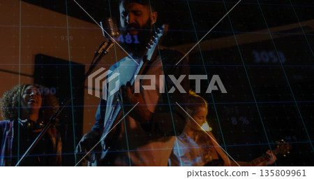 Performing bearded singer playing electric guitar in dim rehearsal studio with blue grid overlay Performing bearded singer playing electric guitar in dim rehearsal studio with blue grid overlay 135809961