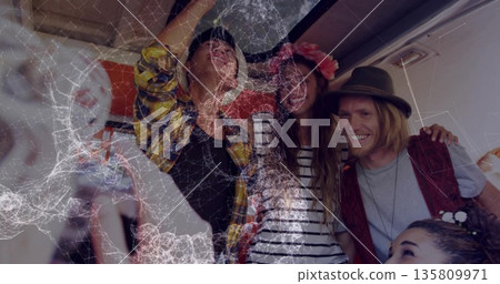 Cheering five travelers standing with arms around other in plane aisle, flower crown and fedora hat 135809971