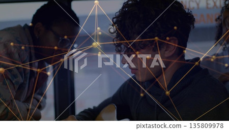 Curly-haired man playing acoustic guitar in studio, with glasses-wearing student and network lines Curly-haired man playing acoustic guitar in studio, with glasses-wearing student and network lines 135809978