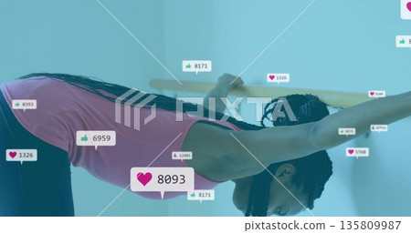 Lady wearing activewear stretching at barre studio, with wooden barre and floating digital icons Lady wearing activewear stretching at barre studio, with wooden barre and floating digital icons 135809987