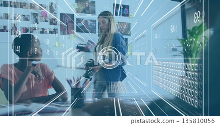 Woman in blazer holding DSLR camera studying holographic charts at office, with pens and notebook Woman in blazer holding DSLR camera studying holographic charts at office, with pens and notebook 135810056