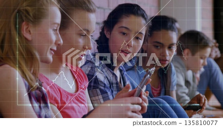 Sitting row of six students focusing on smartphones in learning space, with digital chart overlay 135810077