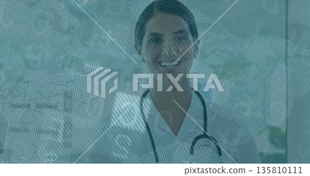 Smiling doctor standing at hospital glass panel, with stethoscope and digital map Smiling doctor standing at hospital glass panel, with stethoscope and digital map 135810111