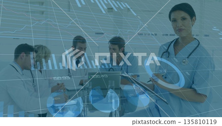 Reviewing charts with team, scrub clad woman holding tablet in hospital conference room, copy space 135810119